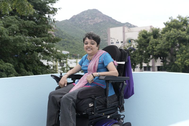 Preethi at Soulfree Inspire rehabilitation facility, with sacred mountain Arunachala in the background 